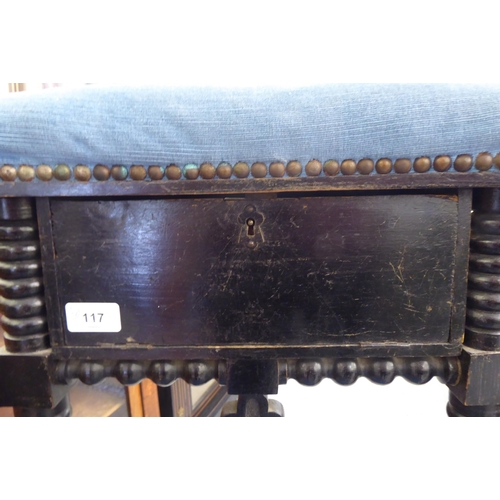 117 - A late Victorian black stained showwood framed prie dieu, upholstered in studded blue dralon and inc... 