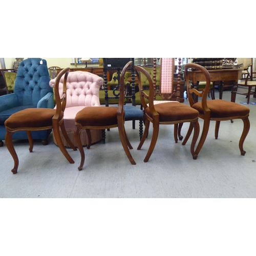 119 - A set of three and one matching late Victorian walnut framed balloon back dining chairs with carved ... 