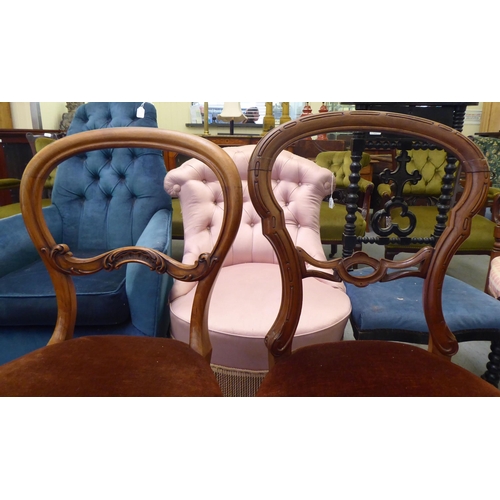 119 - A set of three and one matching late Victorian walnut framed balloon back dining chairs with carved ... 