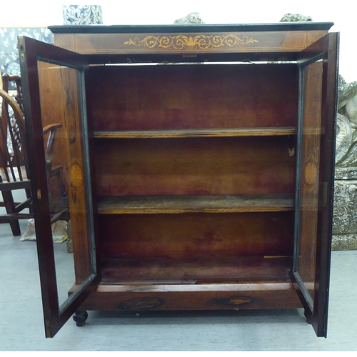 12 - A late Victorian string inlaid painted and rosewood finished pier cabinet, on a plinth and turned fe... 