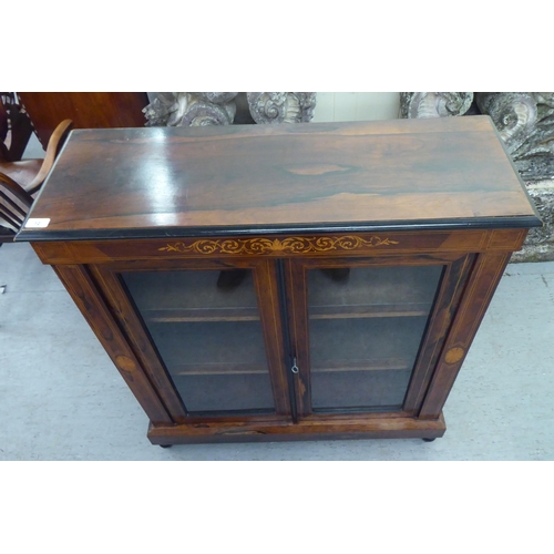 12 - A late Victorian string inlaid painted and rosewood finished pier cabinet, on a plinth and turned fe... 