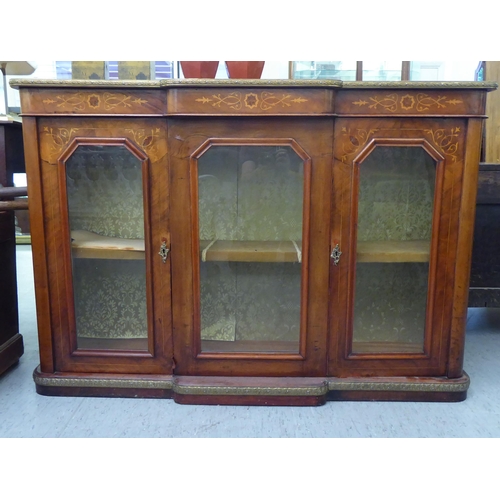 122 - A late 19th/early 20thC Continental figured walnut and marquetry breakfront credenza, comprising thr... 