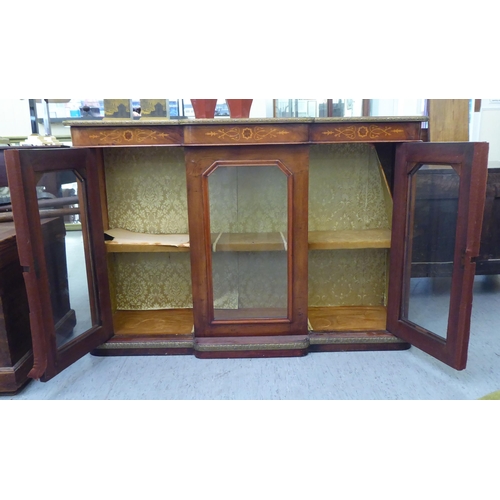 122 - A late 19th/early 20thC Continental figured walnut and marquetry breakfront credenza, comprising thr... 