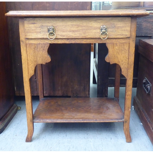 123 - A 1920s light oak occasional table with a shallow drawer, raised on square legs and splayed feet&nbs... 