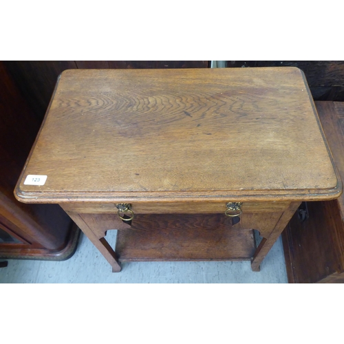 123 - A 1920s light oak occasional table with a shallow drawer, raised on square legs and splayed feet&nbs... 