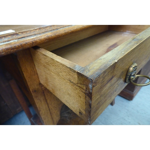 123 - A 1920s light oak occasional table with a shallow drawer, raised on square legs and splayed feet&nbs... 