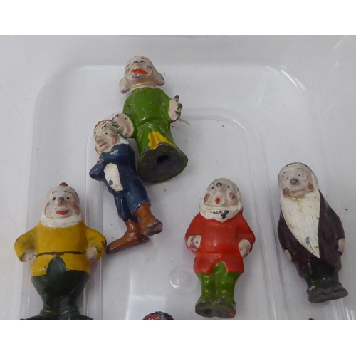 150 - A mid 20thC overpainted cast metal miniature figure, Snow White and the Seven Dwarfs 