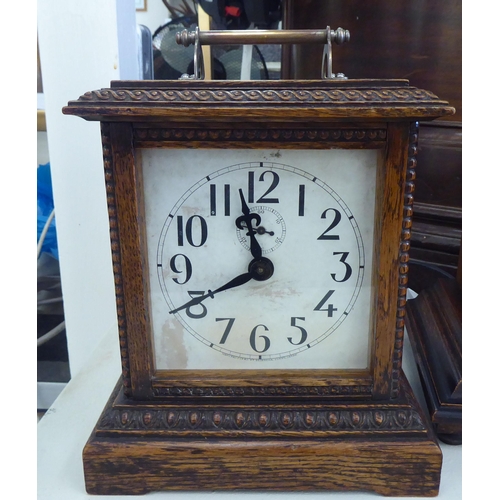 153 - An early 20thC walnut cased mantel clock; the 8 day movement faced by a Roman dial  19