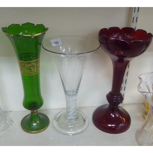 160 - Decorative glassware: to include a green pedestal vase with a castellated top and gilt decoration&nb... 