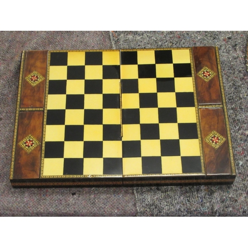 163 - A painted wooden chess set, contained in a marquetry, lacquered, folding box, incorporating a board ... 