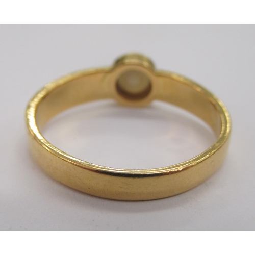 173 - A gold coloured metal antique ring, set with a single pearl 