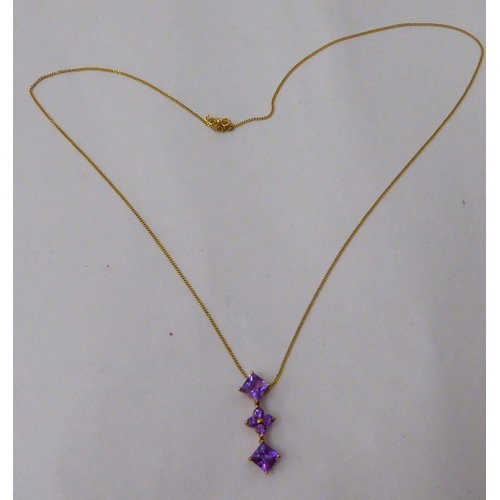 192 - A 9ct gold pendant, set with amethysts, on a fine 9ct gold neckchain 