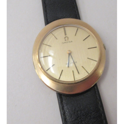 193 - A 9ct gold cased Omega De Ville wristwatch, faced by a baton dial, on a black hide strap