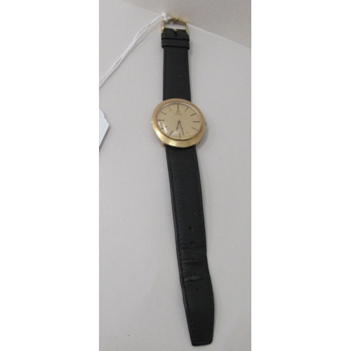 193 - A 9ct gold cased Omega De Ville wristwatch, faced by a baton dial, on a black hide strap