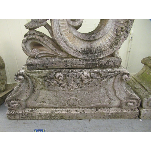 2 - A pair of composition stone, two part Four Seasons terrace ornaments, each featuring a cherubic figu... 