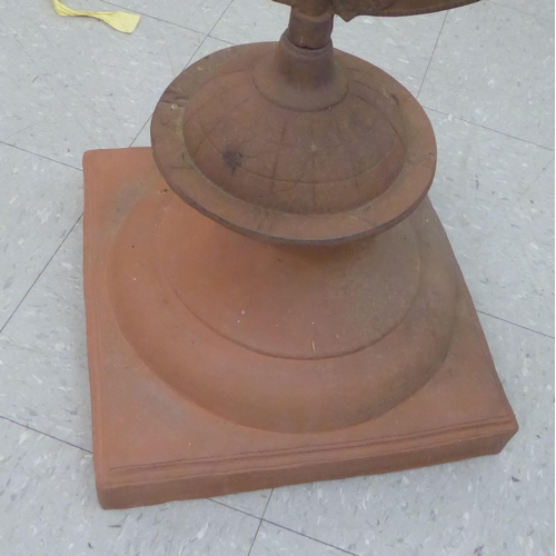 20 - A modern antique finished iron terrace ornament, a sundial set on a terracotta plinth  30