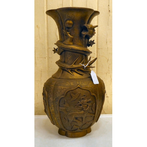 200 - A 20thC Chinese bronze vase, decorated in relief with spiraling dragons and animals  15