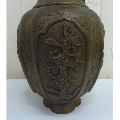 200 - A 20thC Chinese bronze vase, decorated in relief with spiraling dragons and animals  15