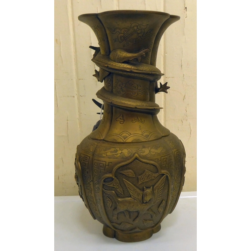 200 - A 20thC Chinese bronze vase, decorated in relief with spiraling dragons and animals  15