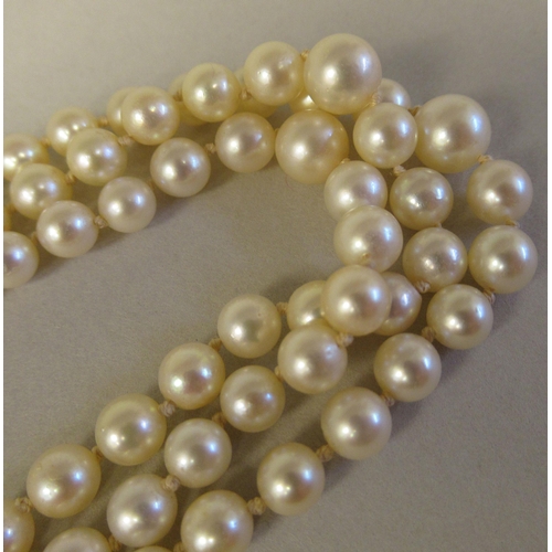 22 - A graduated three row pearl necklace, on a 9ct gold rosette clasp