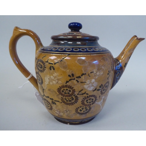 223 - A late 19thC Doulton Lambeth brown and blue glazed stoneware teapot, decorated in Sino-European tast... 