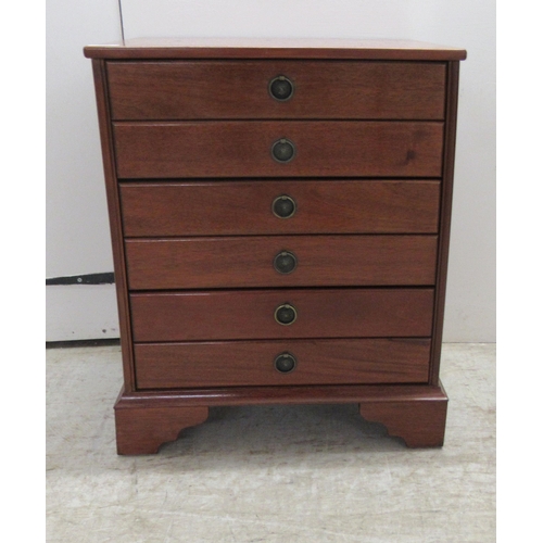 249 - A modern mahogany three drawer chest, fashioned as six facsimiles with provision to hold CD's, raise... 