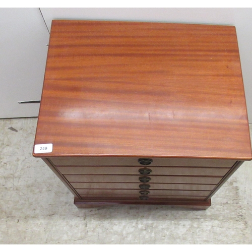 249 - A modern mahogany three drawer chest, fashioned as six facsimiles with provision to hold CD's, raise... 