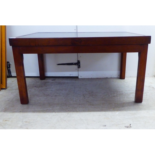 250 - A 20thC mahogany framed coffee table, the top set with a tooled and gilded hide scriber, raised on s... 