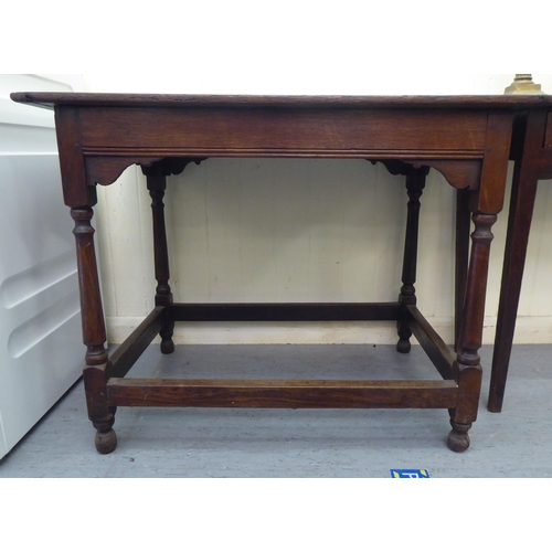 291 - An early 19thC oak side table, raised on turned and block supports, united by stretchers  28