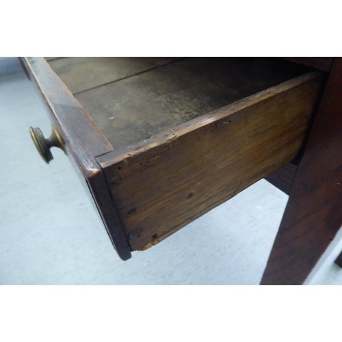 52 - A late 18th/early 19thC oak side table, the plank top over a shallow, long drawer, raised on square,... 