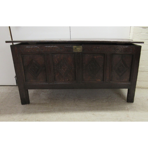 63 - An 18thC country made oak coffer with straight sides and a diamond carved, quadruple panelled front ... 