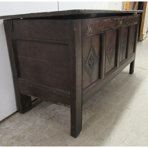 63 - An 18thC country made oak coffer with straight sides and a diamond carved, quadruple panelled front ... 