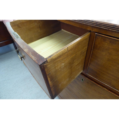 7 - A mid 19thC mahogany bow front dressing chest with two short drawers, over two long drawers, raised ... 