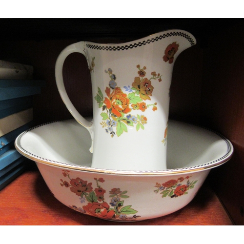 77 - An early 20thC Burleighware china wash bowl and jug, decorated with flora and gilt banding