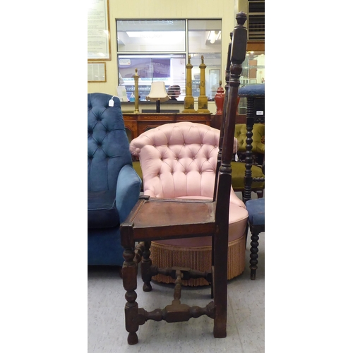 84 - A late 18thC fruitwood, beech and elm side chair, the high back with carved ornament between turned ... 