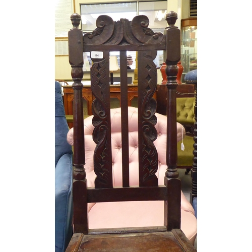 84 - A late 18thC fruitwood, beech and elm side chair, the high back with carved ornament between turned ... 