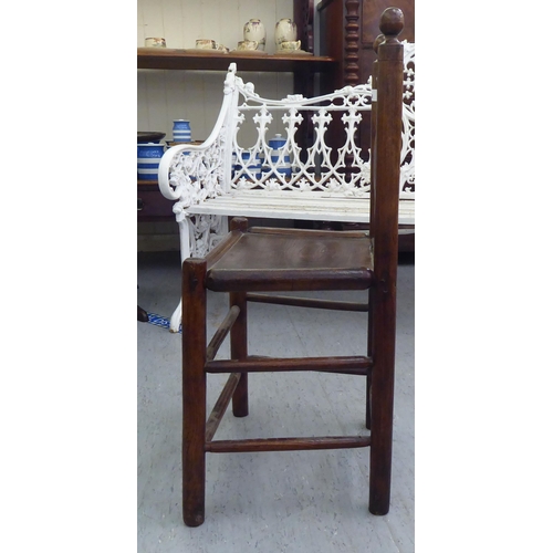 86 - A 19thC child's turned oak and elm framed chair with a triple, elliptical spindled back and hollow s... 