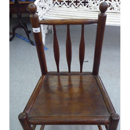 86 - A 19thC child's turned oak and elm framed chair with a triple, elliptical spindled back and hollow s... 