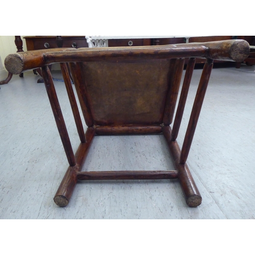 86 - A 19thC child's turned oak and elm framed chair with a triple, elliptical spindled back and hollow s... 