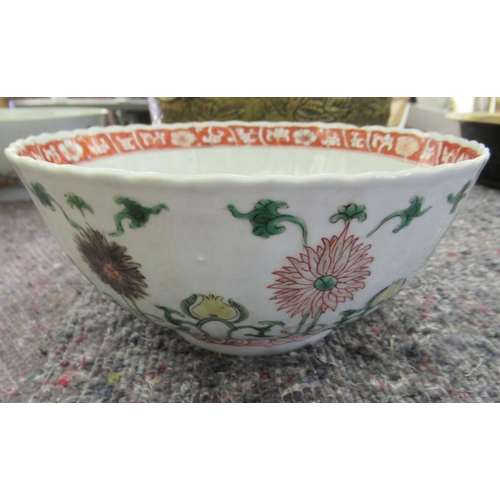 91 - An early 18thC Chinese porcelain bowl of ribbed design, decorated with floral motifs  bears a p... 