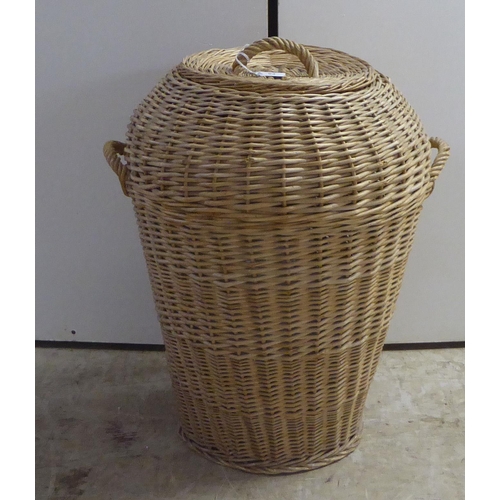 93 - An Ali Baba vase style twin handled woven cane linen bin and cover  27