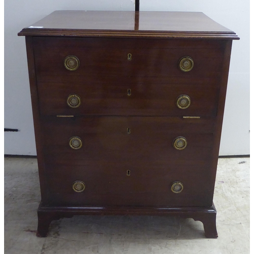 97 - A late Georgian mahogany night commode, in the style of a dressing chest with lacquered brass flank ... 