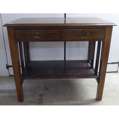 98 - A 1920s mahogany office work table, the pair of shallow, linen drawers with brass bail handles, rais... 