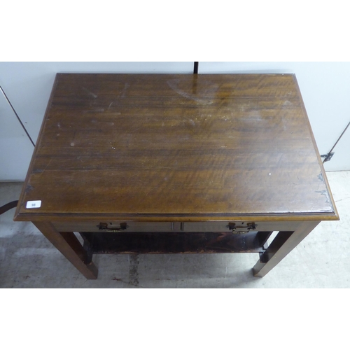 98 - A 1920s mahogany office work table, the pair of shallow, linen drawers with brass bail handles, rais... 