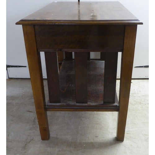 98 - A 1920s mahogany office work table, the pair of shallow, linen drawers with brass bail handles, rais... 