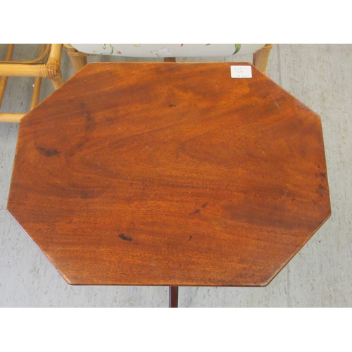 129 - A 19thC mahogany pedestal table, the elongated octagonal top over a ring turned column, raised on a ... 