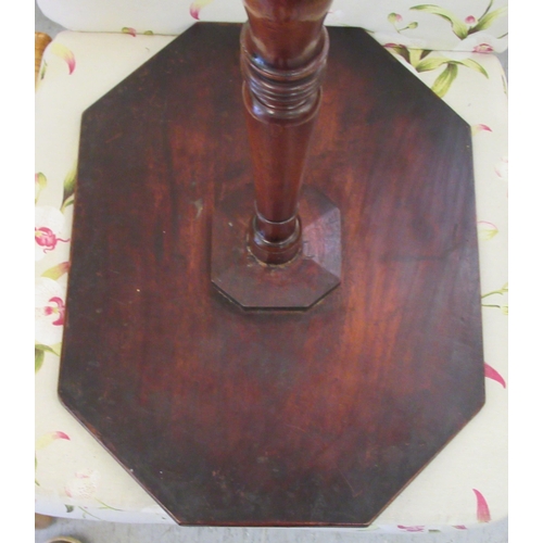 129 - A 19thC mahogany pedestal table, the elongated octagonal top over a ring turned column, raised on a ... 