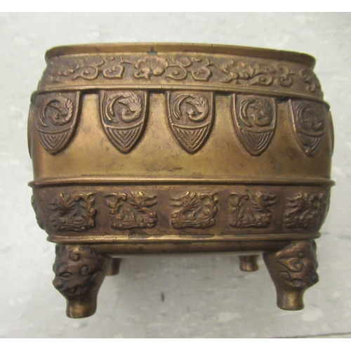 194 - An early 20thC Chinese bronze censer, cast with animal and cloud motifs, on mask feet  3.5