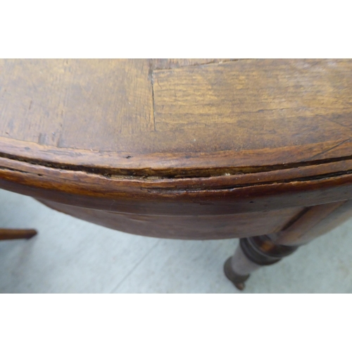 118 - A late 19thC Continental cherrywood oval dining table with a hardwood parquet finished top, over a d... 