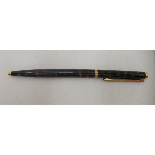 136 - A Dunhill ballpoint pen with a turning roller, gold plating and tortoiseshell effect ccasing  c... 